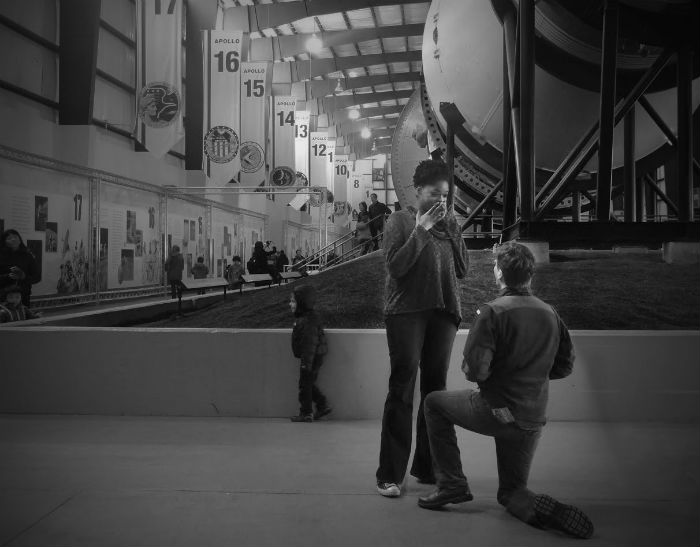 Rob, on bended knee, proposing to Shawna in the NASA Johnson Space Center in Houston